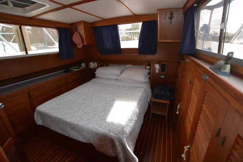 Slide: The Image of Cozy cabin interior of 1998 Monk Trawler with wooden furnishings and a comfortable bed. - 14