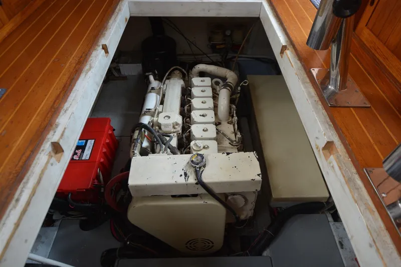 Slide: The Image of Engine compartment of a 1998 Monk Trawler, featuring a diesel engine and battery setup. - 17