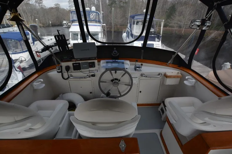 Slide: The Image of 1998 Monk Trawler helm with steering wheel, navigation equipment, and comfortable seating. - 5