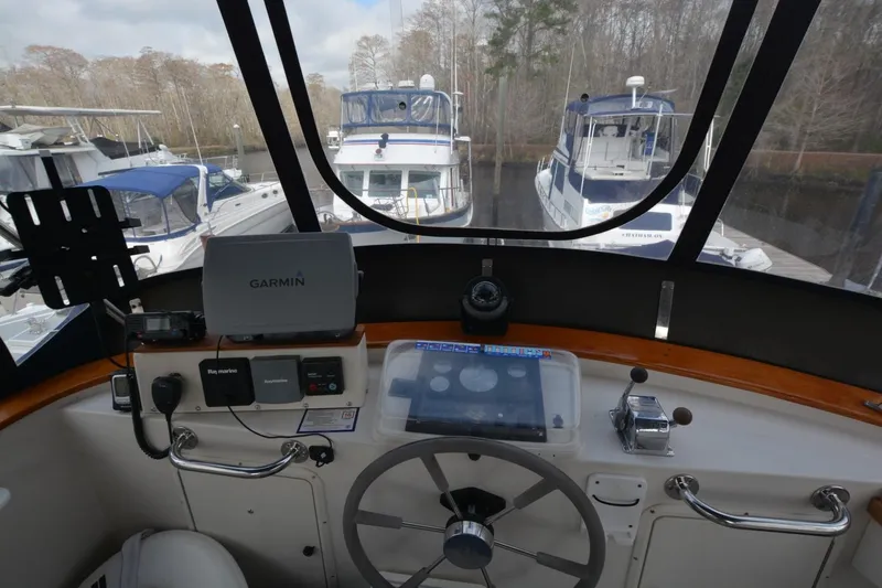 Slide: The Image of 1998 Monk Trawler helm with Garmin navigation, docked near other boats. - 6