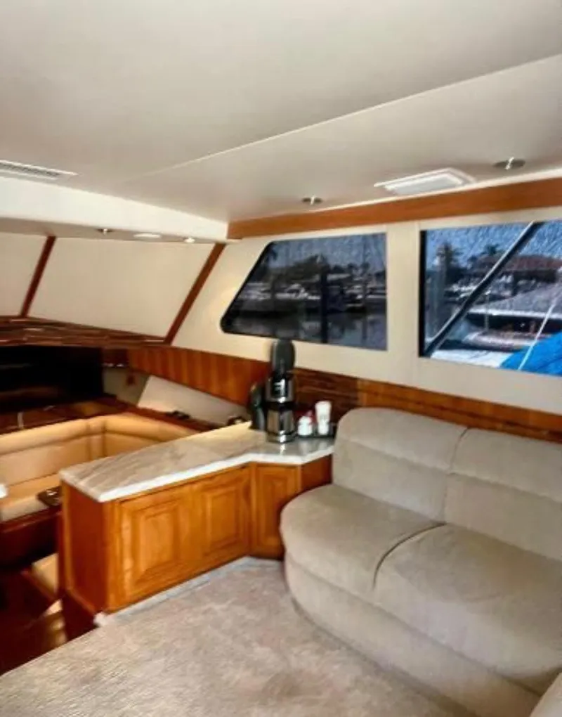 Slide: The Image of Interior of 1994 Viking 38 Convertible yacht with cozy seating and large windows. - 3