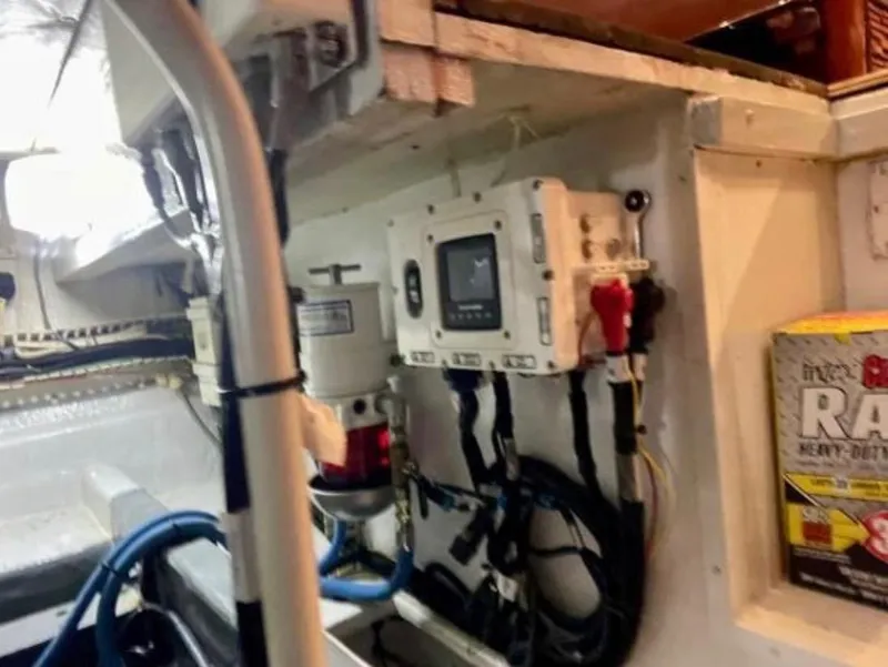Slide: The Image of Engine room of 1994 Viking 38 Convertible boat with control panel and wiring. - 7