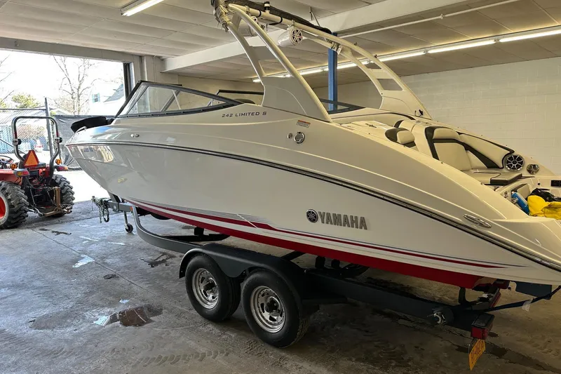 Slide: The Image of 2019 Yamaha Boats 242 Limited S on trailer in garage setting. - 2