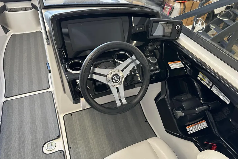 Slide: The Image of 2019 Yamaha Boats 242 Limited S cockpit with steering wheel and control panel. - 6