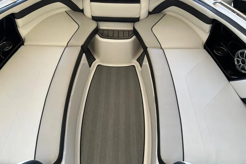 Slide: The Image of 2019 Yamaha Boats 242 Limited S interior with white seating and sleek design. - 8