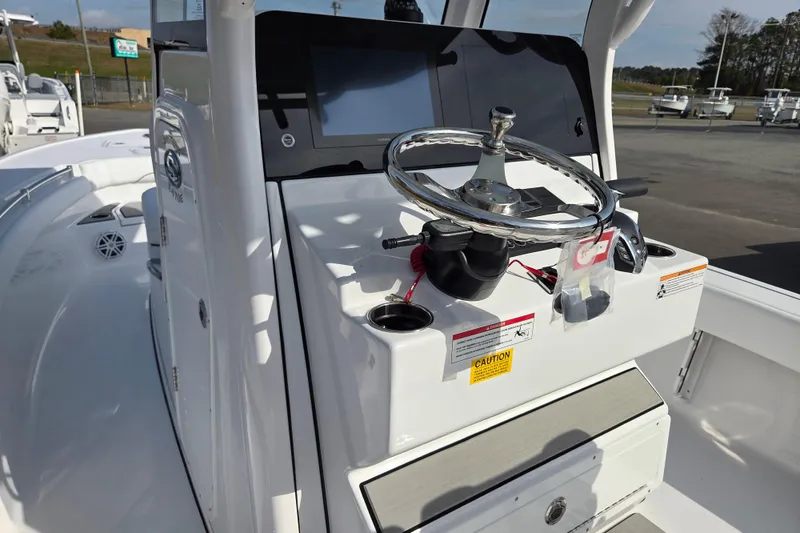 Slide: The Image of 2026 Sportsman Masters 247OE Bay Boat helm with steering wheel and control panel. - 12