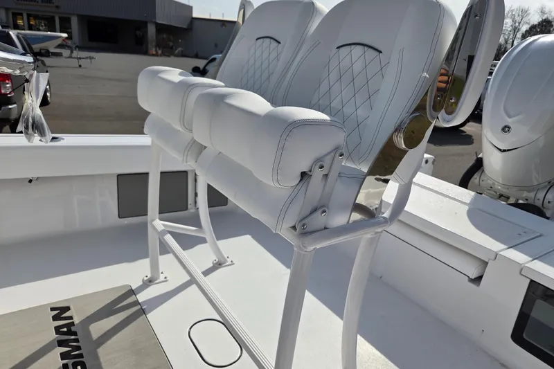 Slide: The Image of 2026 Sportsman Masters 247OE Bay Boat with white cushioned seating and sleek design. - 13
