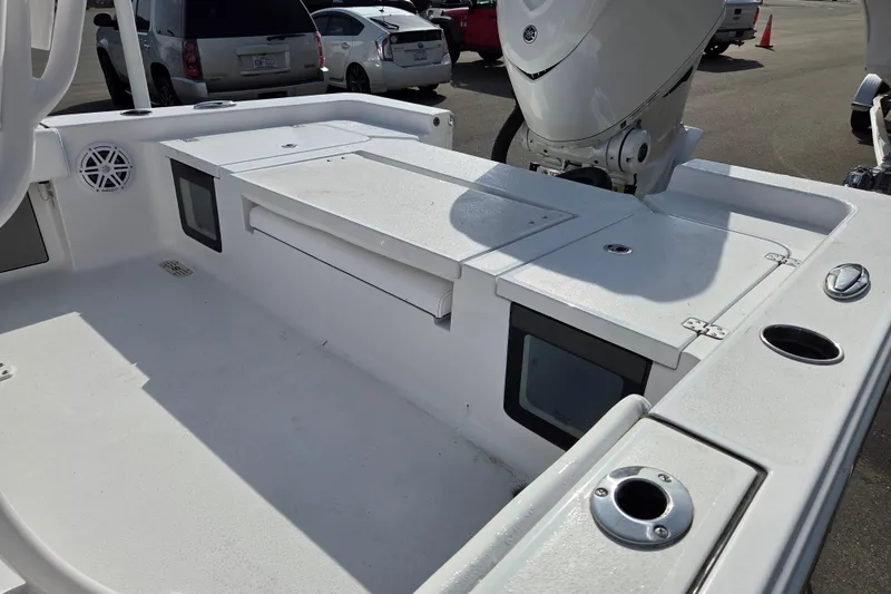 Slide: The Image of 2026 Sportsman Masters 247OE Bay Boat deck with storage compartments and motor. - 16