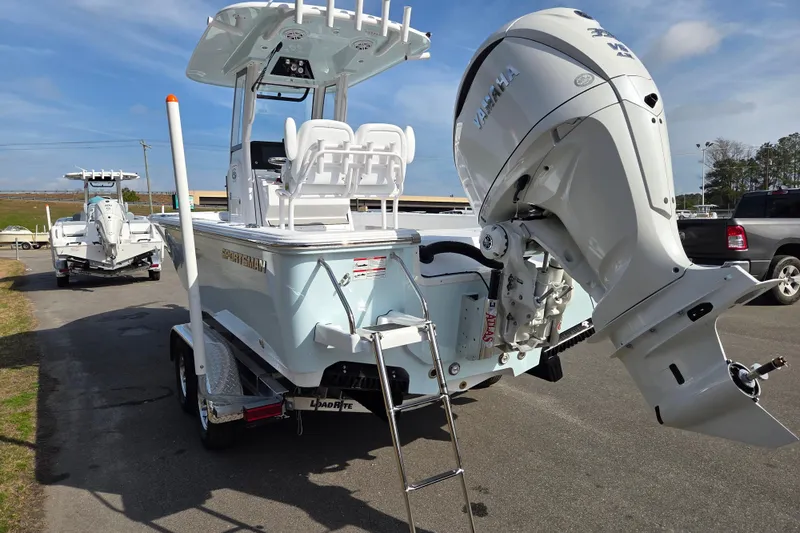 Slide: The Image of 2026 Sportsman Masters 247OE Bay Boat with Yamaha engine on trailer, parked outdoors. - 4