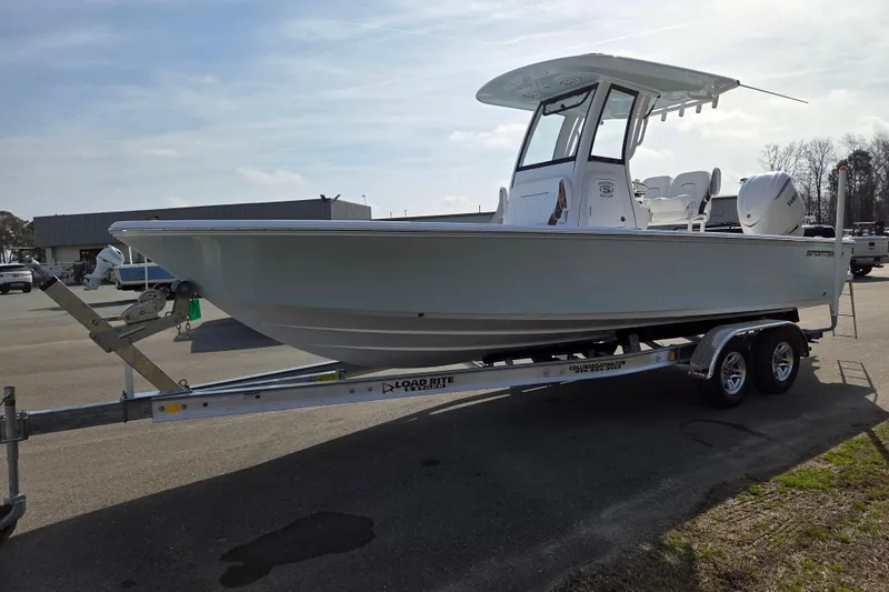 Slide: The Image of 2026 Sportsman Masters 247OE Bay Boat on trailer, parked outdoors. - 7