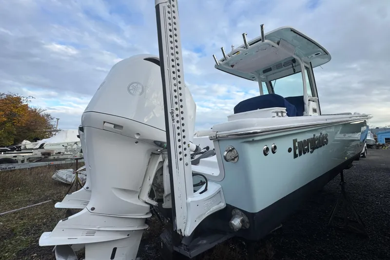Slide: The Image of 2019 Everglades 273 Center Console boat with powerful outboard motor, docked outdoors. - 2