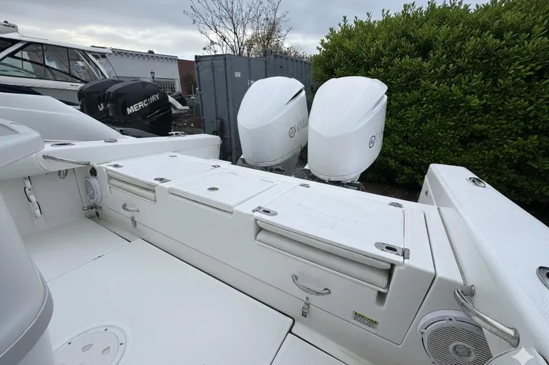 Slide: The Image of 2019 Everglades 273 Center Console boat with dual outboard engines, docked outdoors. - 5