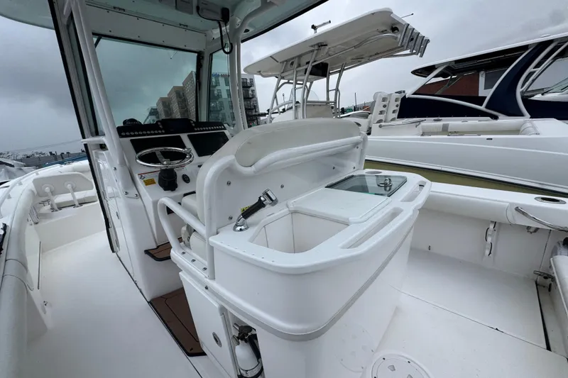 Slide: The Image of 2019 Everglades 273 Center Console boat interior with steering wheel and seating. - 8
