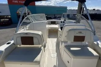 Slide: The Image of 2023 Cobia 220 Dual Console boat interior with seating and dashboard view. - 14