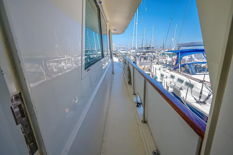 Slide: The Image of Side deck view of 1987 Hatteras 58 Motor Yacht in marina. - 14