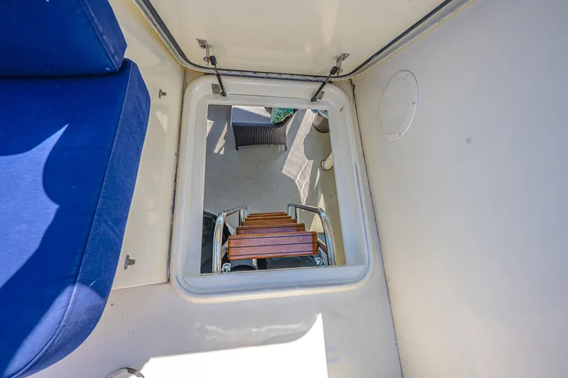 Slide: The Image of Hatteras 58 Motor Yacht 1987 interior hatch with wooden steps and blue seating. - 19