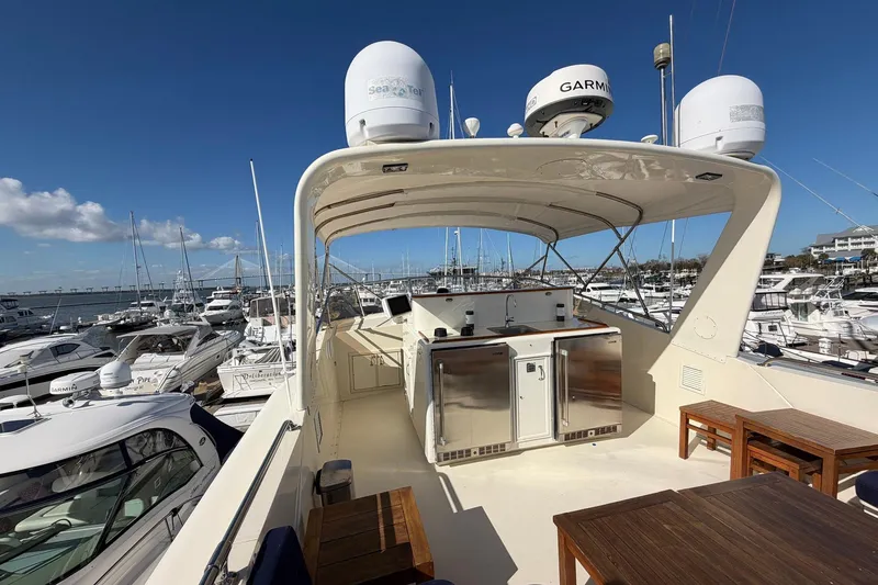 Slide: The Image of 1987 Hatteras 58 Motor Yacht docked, featuring spacious deck and modern amenities. - 20