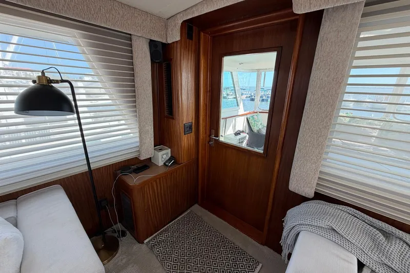 Slide: The Image of Interior of 1987 Hatteras 58 Motor Yacht with cozy seating and nautical decor. - 29