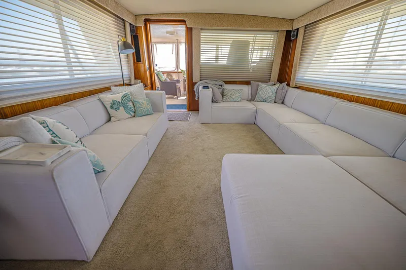 Slide: The Image of Luxurious interior of 1987 Hatteras 58 Motor Yacht with spacious seating and elegant decor. - 30