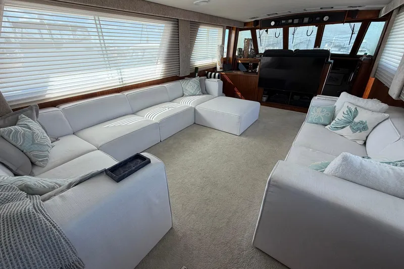 Slide: The Image of Luxurious interior of 1987 Hatteras 58 Motor Yacht with plush white seating and nautical decor. - 31