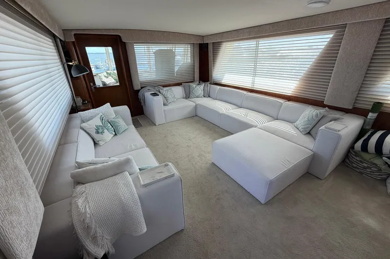 Slide: The Image of Luxurious interior of 1987 Hatteras 58 Motor Yacht with plush white seating and large windows. - 32