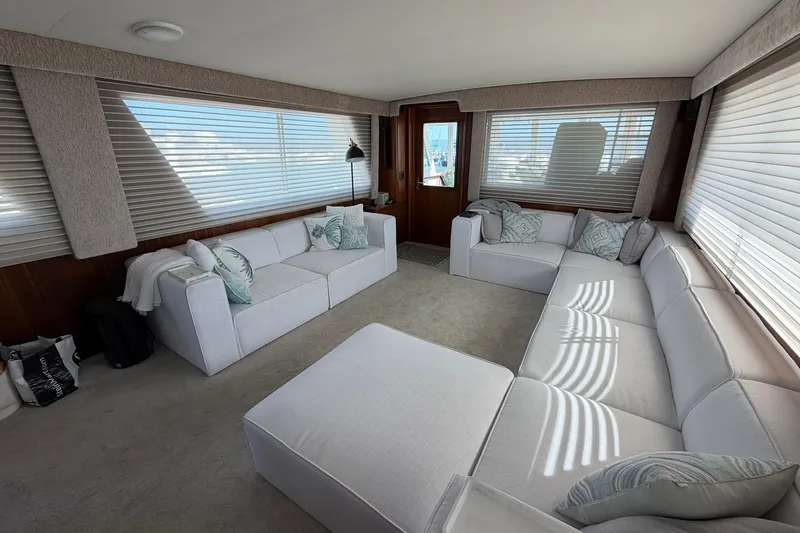 Slide: The Image of Luxurious interior of 1987 Hatteras 58 Motor Yacht with plush white seating and large windows. - 33