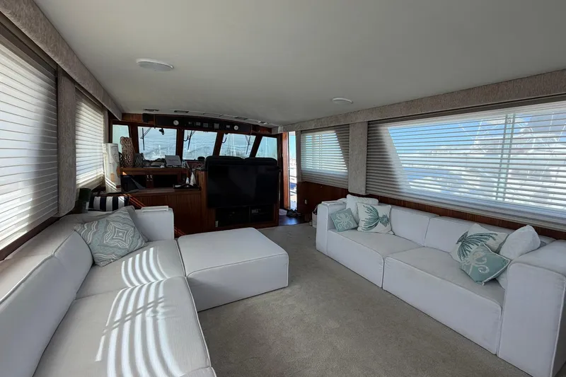 Slide: The Image of Luxurious interior of 1987 Hatteras 58 Motor Yacht with white sofas and large windows. - 34