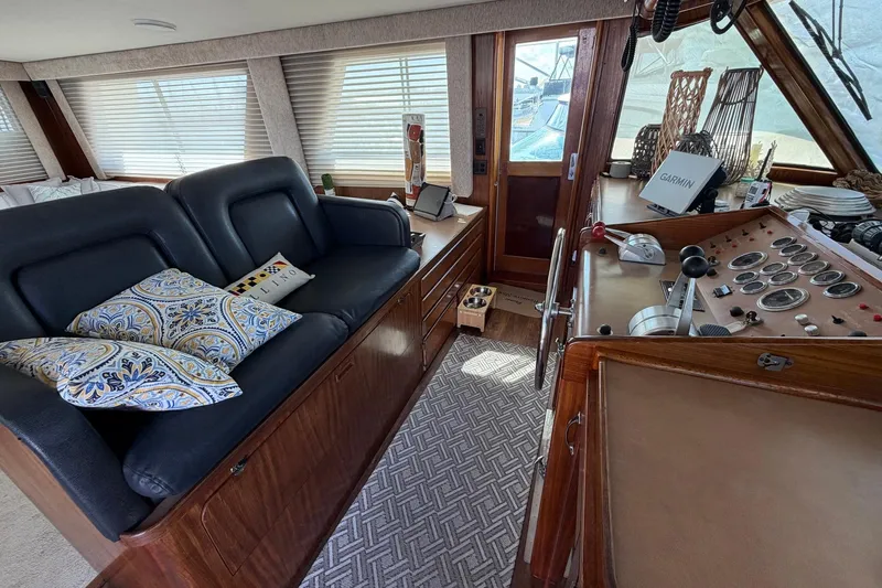 Slide: The Image of 1987 Hatteras 58 Motor Yacht interior with helm, seating, and navigation equipment. - 38