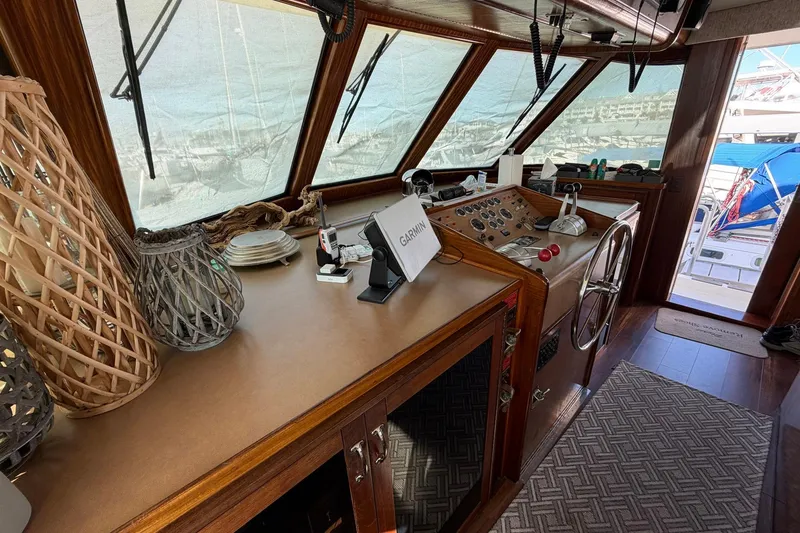 Slide: The Image of 1987 Hatteras 58 Motor Yacht helm with wooden accents and navigation equipment. - 39