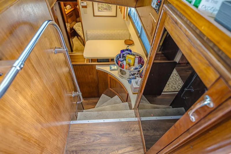 Slide: The Image of Interior of 1987 Hatteras 58 Motor Yacht with wooden stairs and dining area. - 40