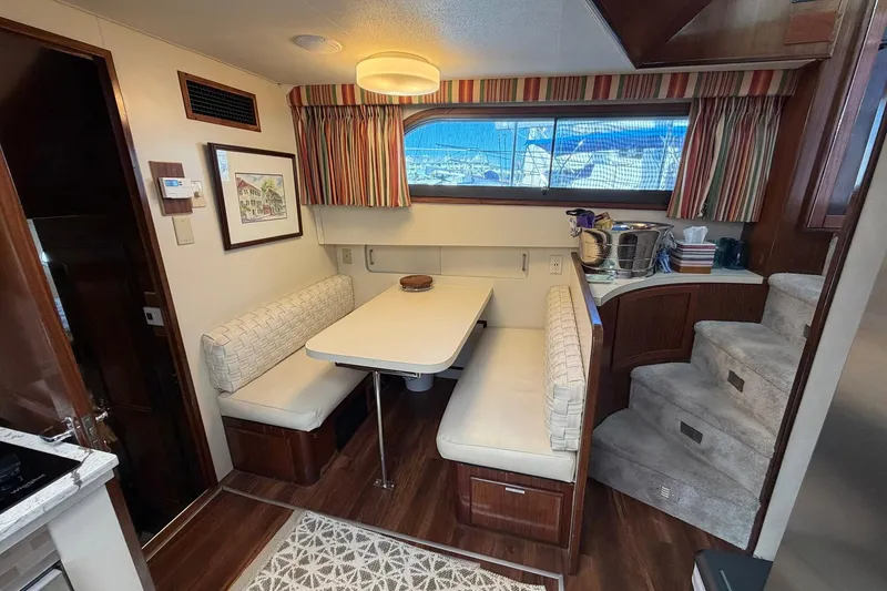 Slide: The Image of Interior of 1987 Hatteras 58 Motor Yacht with dining area and staircase. - 41