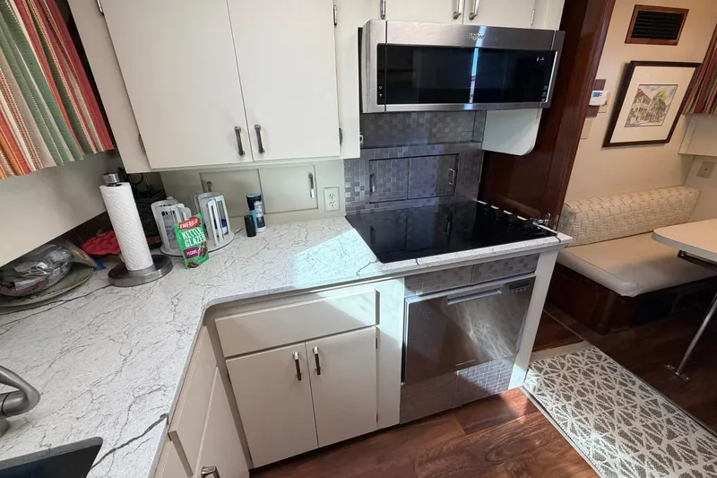 Slide: The Image of Modern kitchen in 1987 Hatteras 58 Motor Yacht with sleek appliances and cozy dining area. - 44