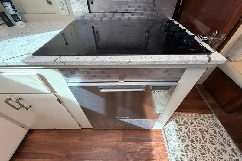 Slide: The Image of Modern kitchen area in a 1987 Hatteras 58 Motor Yacht with stovetop and dishwasher. - 45