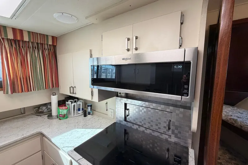 Slide: The Image of Modern kitchen in 1987 Hatteras 58 Motor Yacht with microwave and sleek countertops. - 46