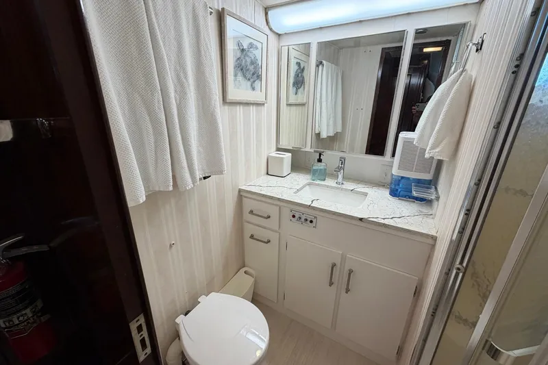 Slide: The Image of Bathroom interior of 1987 Hatteras 58 Motor Yacht with sink, mirror, and toilet. - 50