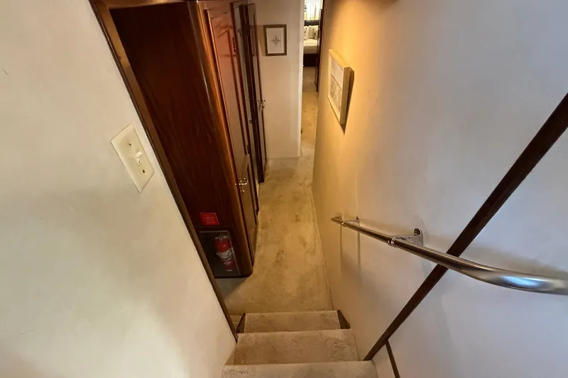 Slide: The Image of Stairway inside 1987 Hatteras 58 Motor Yacht with wooden accents and handrail. - 52