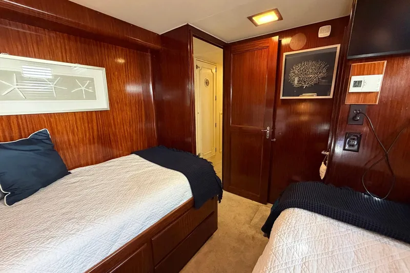 Slide: The Image of Interior cabin of 1987 Hatteras 58 Motor Yacht with twin beds and wood paneling. - 54