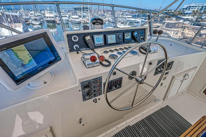 Slide: The Image of Helm of 1987 Hatteras 58 Motor Yacht with navigation equipment and steering wheel. - 65