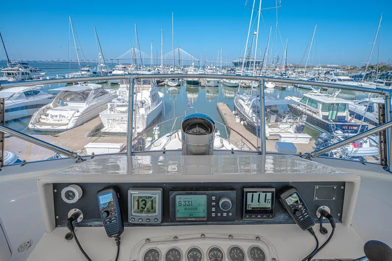 Slide: The Image of Helm view from 1987 Hatteras 58 Motor Yacht in a busy marina. - 66