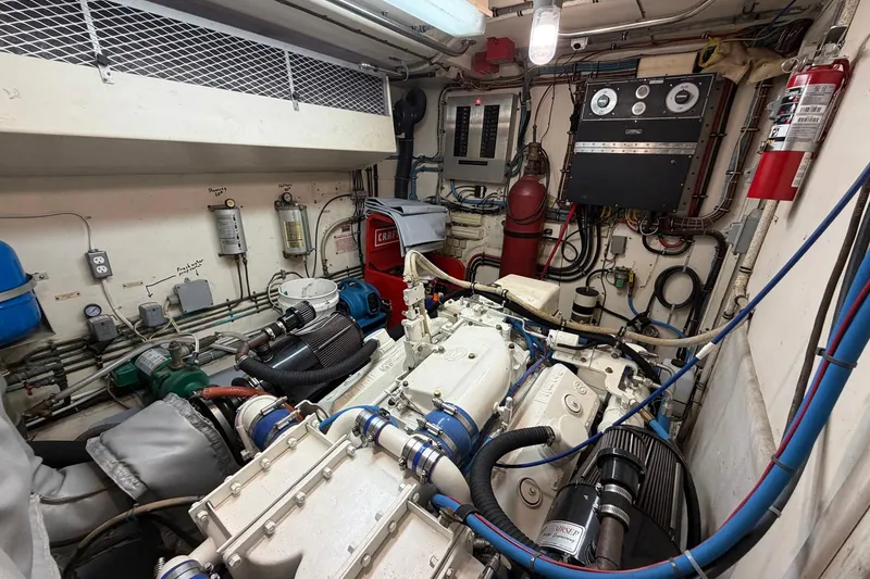 Slide: The Image of Engine room of a 1987 Hatteras 58 Motor Yacht with complex machinery and wiring. - 69