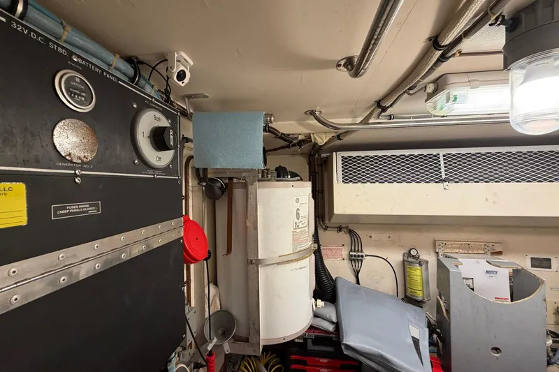 Slide: The Image of Engine room of 1987 Hatteras 58 Motor Yacht with control panels and equipment. - 70