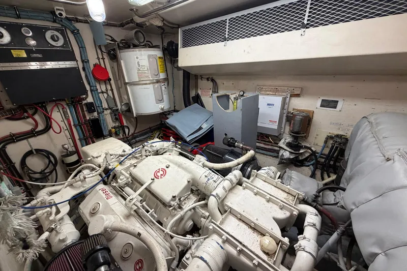 Slide: The Image of Engine room of a 1987 Hatteras 58 Motor Yacht, showcasing machinery and equipment. - 73