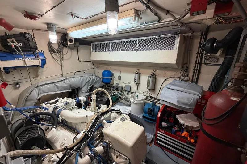 Slide: The Image of Engine room of 1987 Hatteras 58 Motor Yacht with tools and equipment. - 74