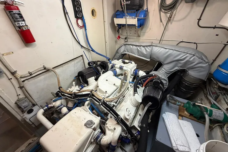 Slide: The Image of Engine room of a 1987 Hatteras 58 Motor Yacht, featuring complex machinery and equipment. - 75