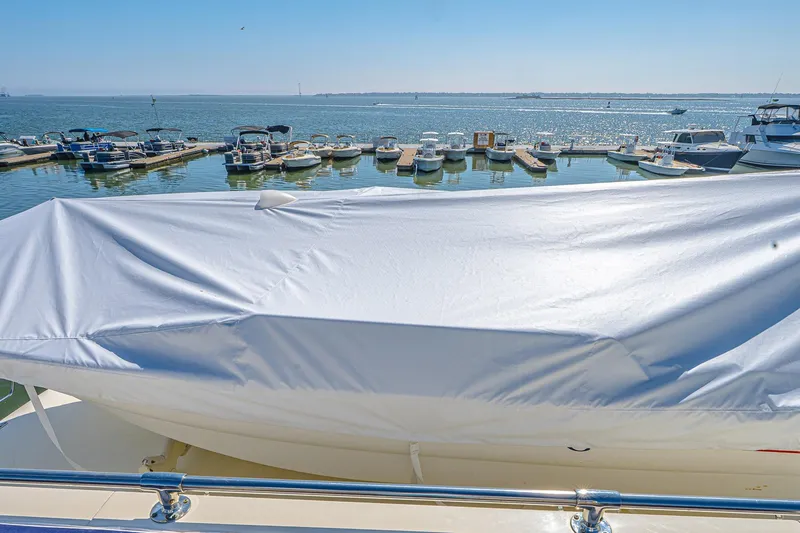 Slide: The Image of 1987 Hatteras 58 Motor Yacht with covered deck, docked at marina. - 84