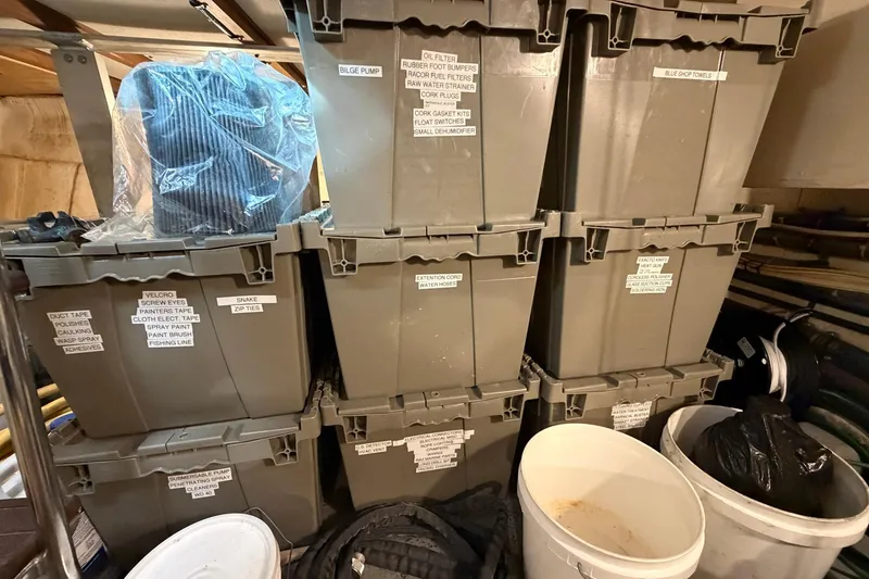 Slide: The Image of Storage area with labeled bins and buckets on a 1987 Hatteras 58 Motor Yacht. - 87