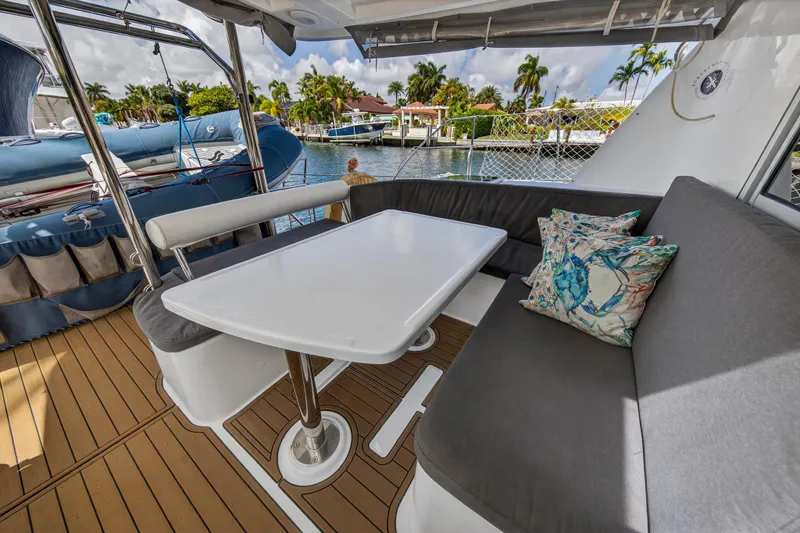 Slide: The Image of 2012 Leopard 39 catamaran docked with dinghy, showcasing sleek design and spacious deck. - 13