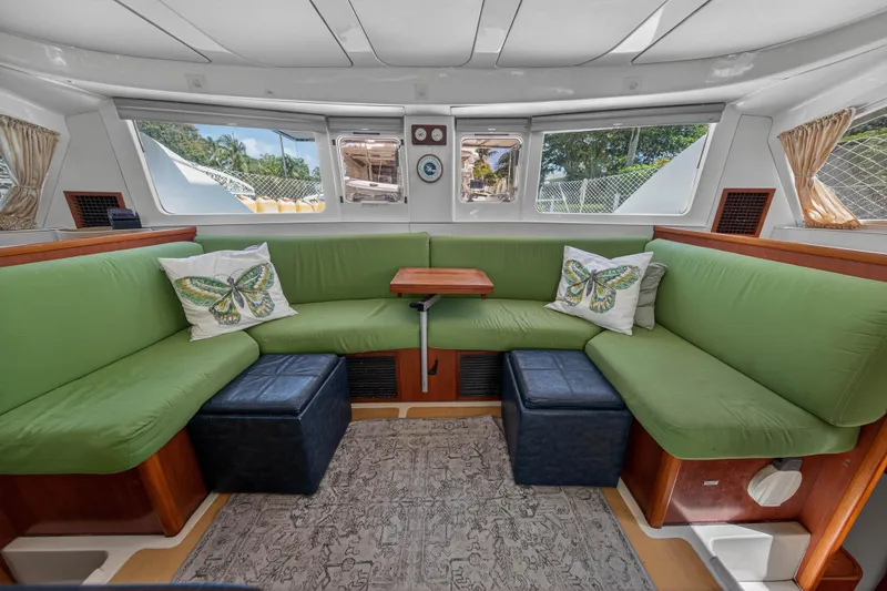 Slide: The Image of Interior of 2012 Leopard 39 yacht with green seating, butterfly pillows, and large windows. - 20