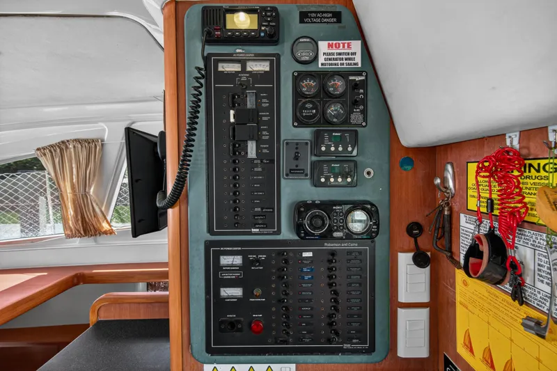 Slide: The Image of Control panel inside a 2012 Leopard 39 yacht, featuring gauges and switches. - 24