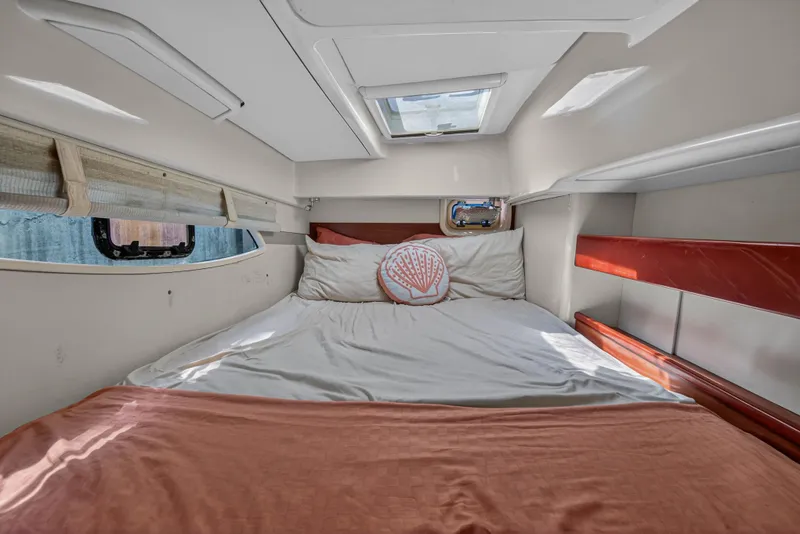 Slide: The Image of Cozy cabin interior of 2012 Leopard 39 yacht with bed and porthole window. - 28